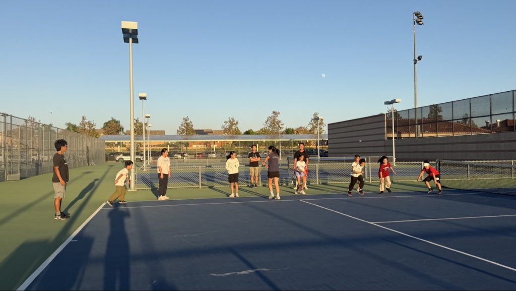 Insight Youth students and coaches at the weekly tennis session on the high school tennis courts